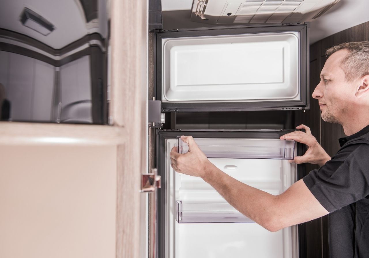 Interior of RV kitchen with common appliances needing repair