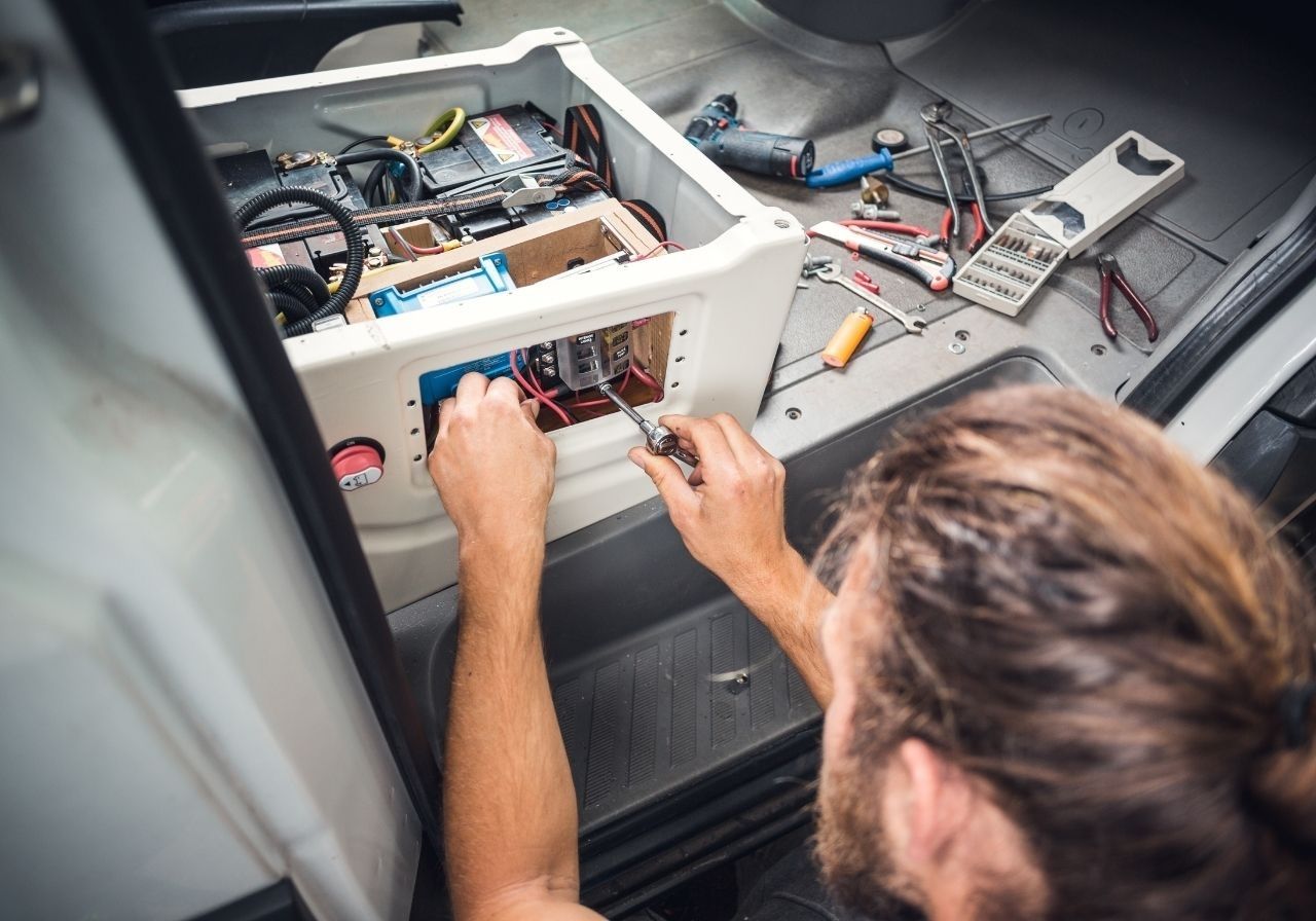 Diagnosing RV fuse panel with multimeter during on-site electrical service