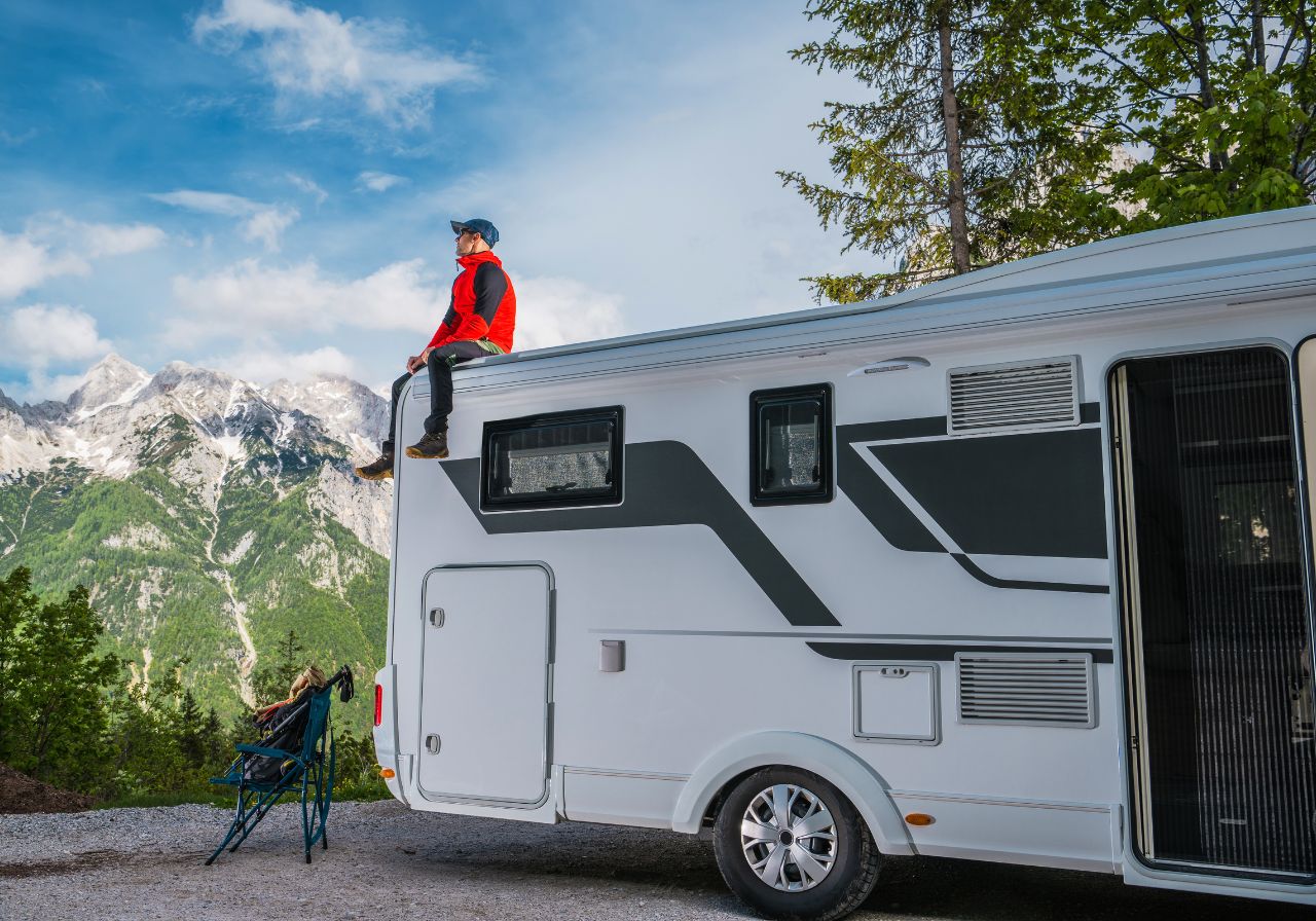 Mobile RV repair expert standing next to fully-equipped service van