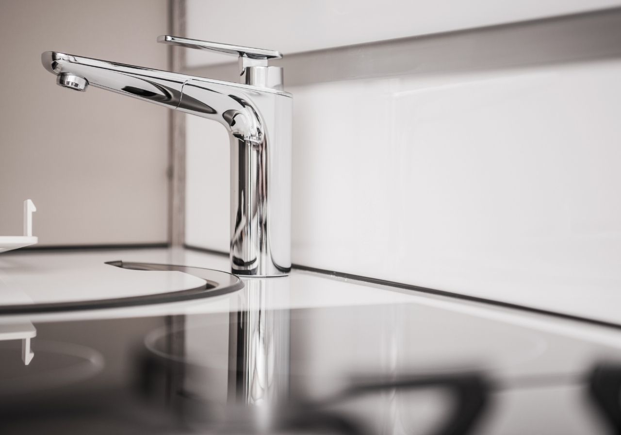 Close-up of RV fresh water tank and plumbing system being inspected on-site