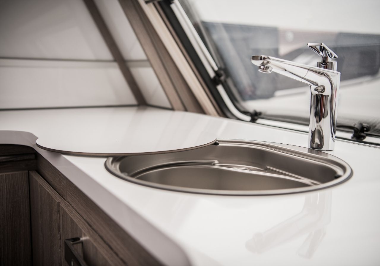 Frustrated RV owner checking under the sink while parked at a campground