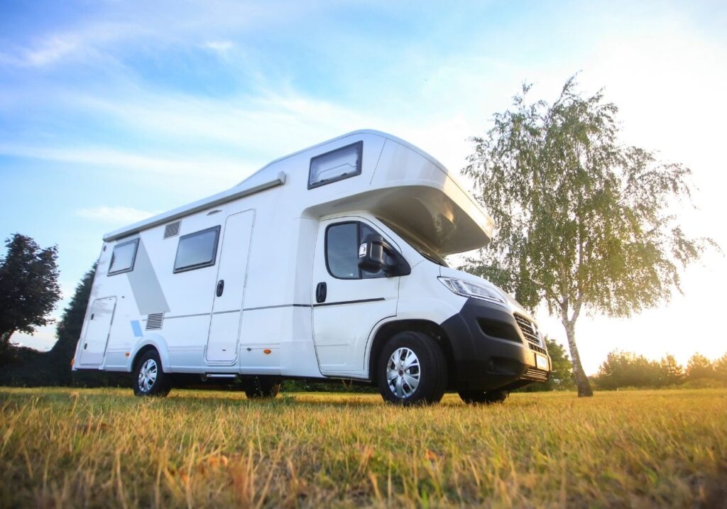 Various RV types including motorhomes and trailers lined up in campground